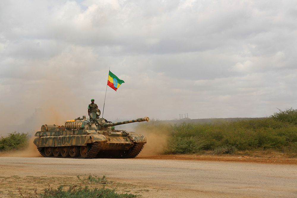 A member of the ENDF drives past in a tank during an End of Tour of Duty ceremony performed in front of AMISOM Force…