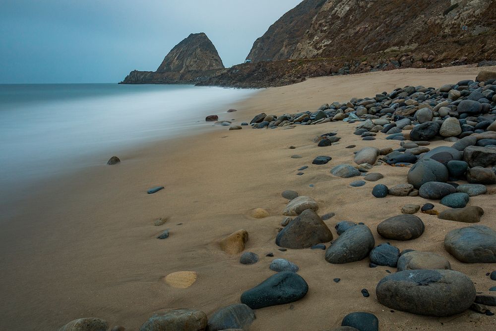 Blue foggy beach with pubble. Original public domain image from Flickr