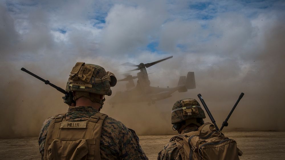 U.S. Marine Corps joint terminal attack controllers communicate with a MV-22 Osprey during takeoff in Hokkaido, Japan, Aug.…