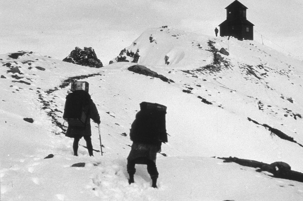 Two unidentified people taking up supplies to Mt Hood lookout. Original public domain image from Flickr