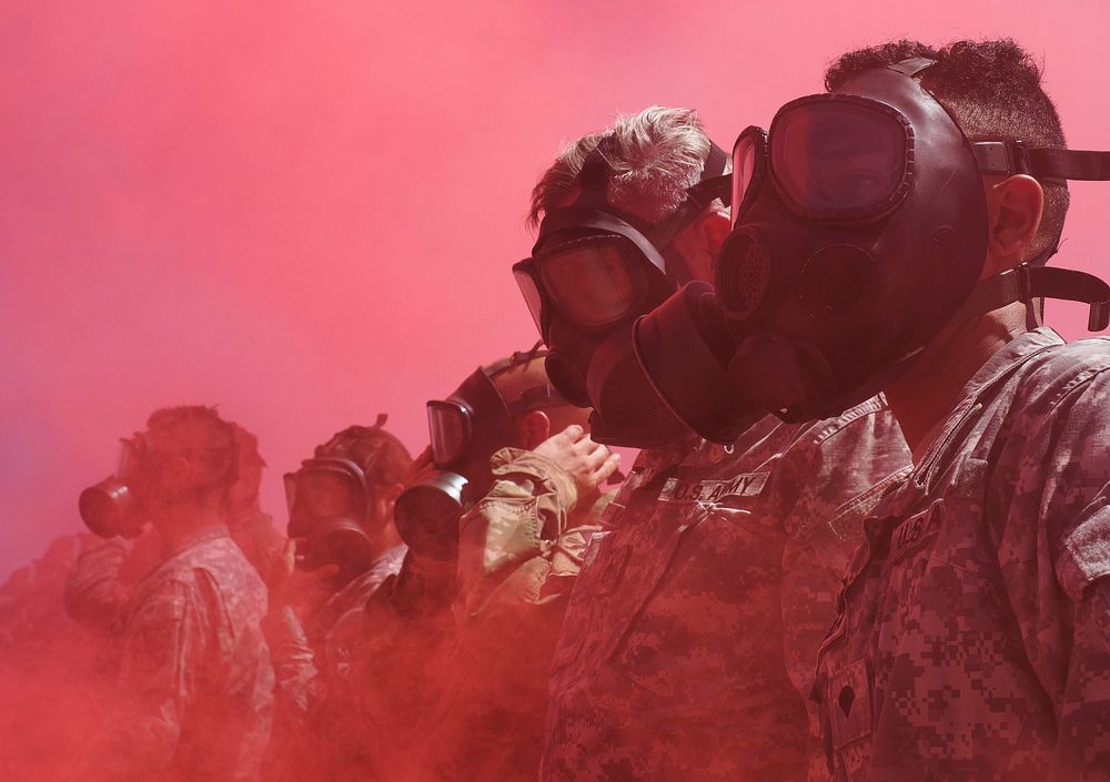 Arizona Army National Guard Soldiers from the 2220th Transportation Company are engulfed by colored smoke after putting on…