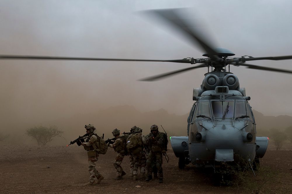 U.S. Air Force pararescuemen assigned to the 48th Rescue Squadron and French Air Commandos provide cover after moving a…