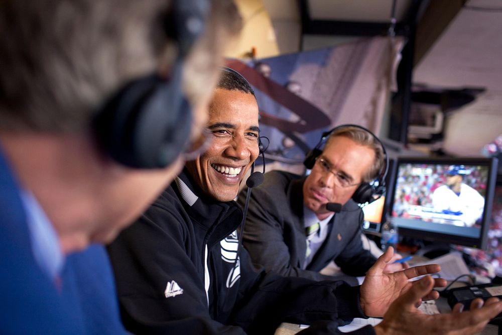 President Barack Obama joins Fox Sports announcers Joe Buck, right, and Tim McCarver, left, in the broadcast booth at the…