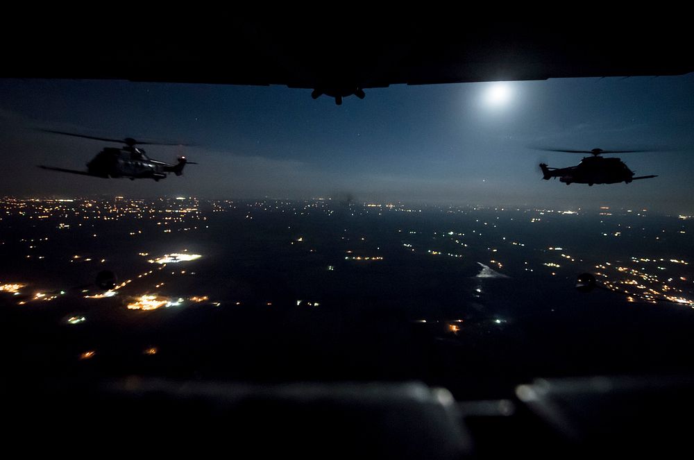 Two French Air Force EC-725 Super Cougar helicopters receive fuel from a U.S. Air Force MC-130H Combat Talon II during a…