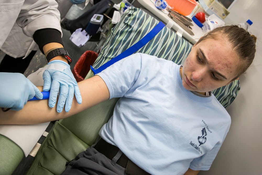 Phlebotomist Sandra Rodriguez, left, Miller Keystone Blood Center, Ewing, N.J., prepares to remove a blood donation needle…