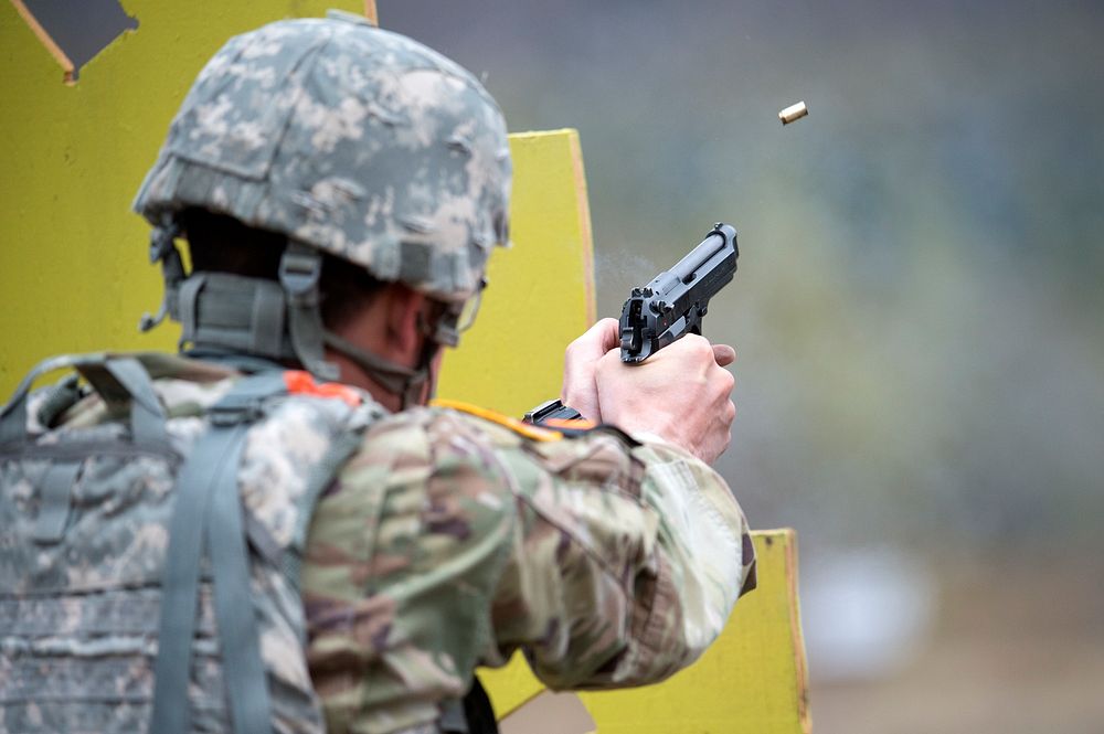 Montana Army National Guard Spc. Tucker Zimmerman fires a M9 pistol while competing in a maneuver and fire event during the…