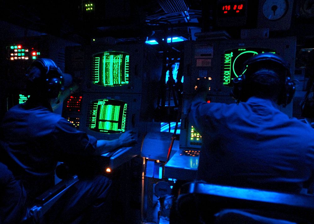 U.S. Navy sonar technicians aboard the guided-missile destroyer USS The Sullivans (DDG 68) monitor sonar equipment for…
