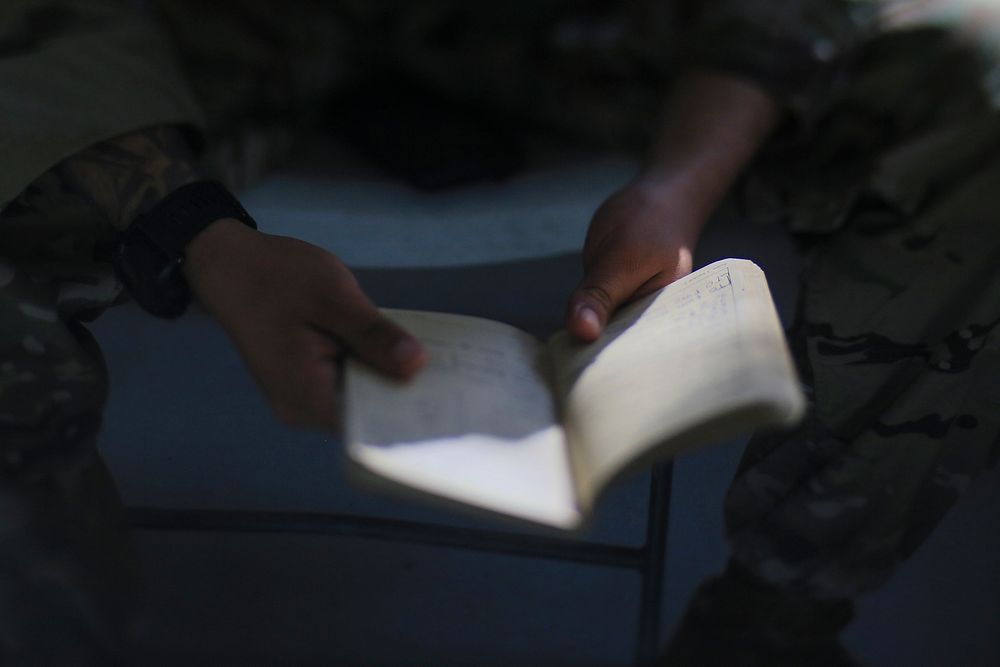 Soldier reading his journal. Original public domain image from Flickr