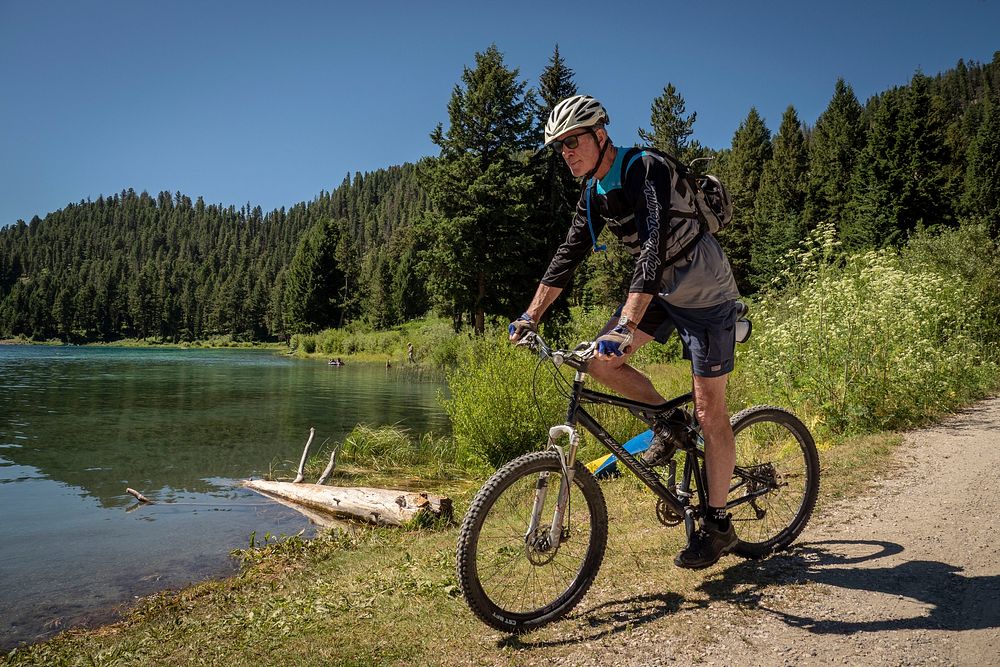 A man mountain bikes near Wade Lake in the Beaverhead-Deerlodge National Forest.