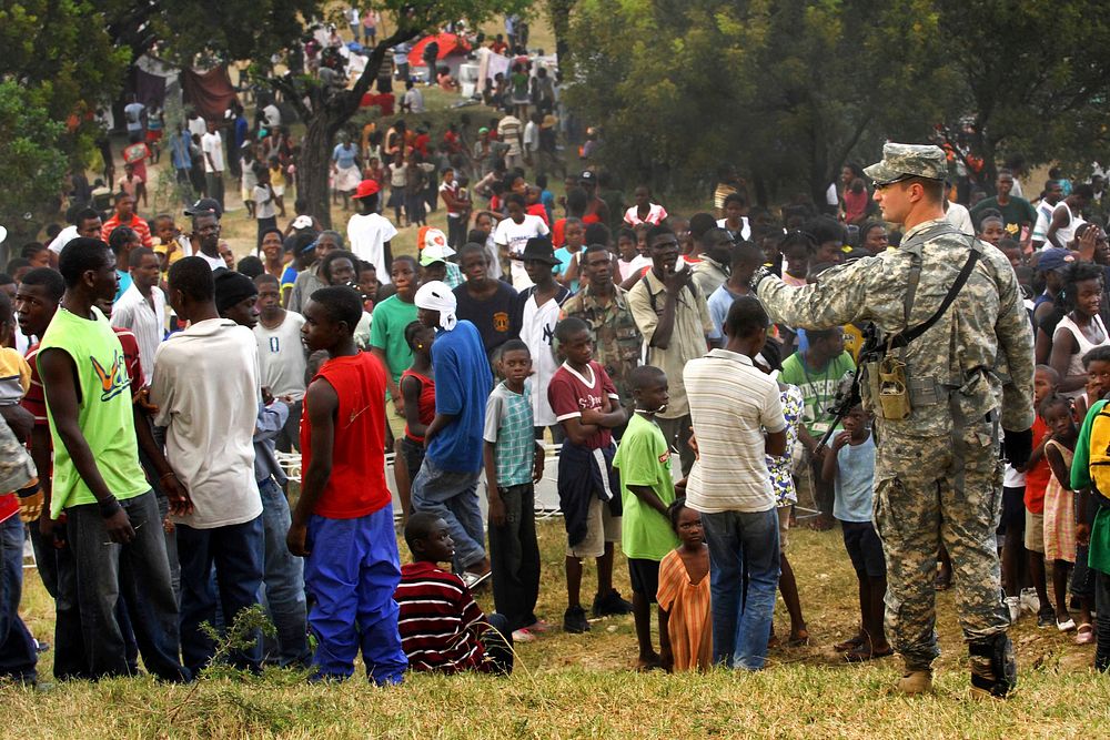 A crowd gathers in an area U.S. soldiers are using as a a forward operating base in Port-au-Prince, Haiti, Jan. 16, 2010.