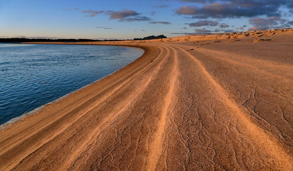 Tide lines at Sunset. Sunset at the Ruakaka river mouth Beam Bay Northland NZ. Original public domain image from Flickr