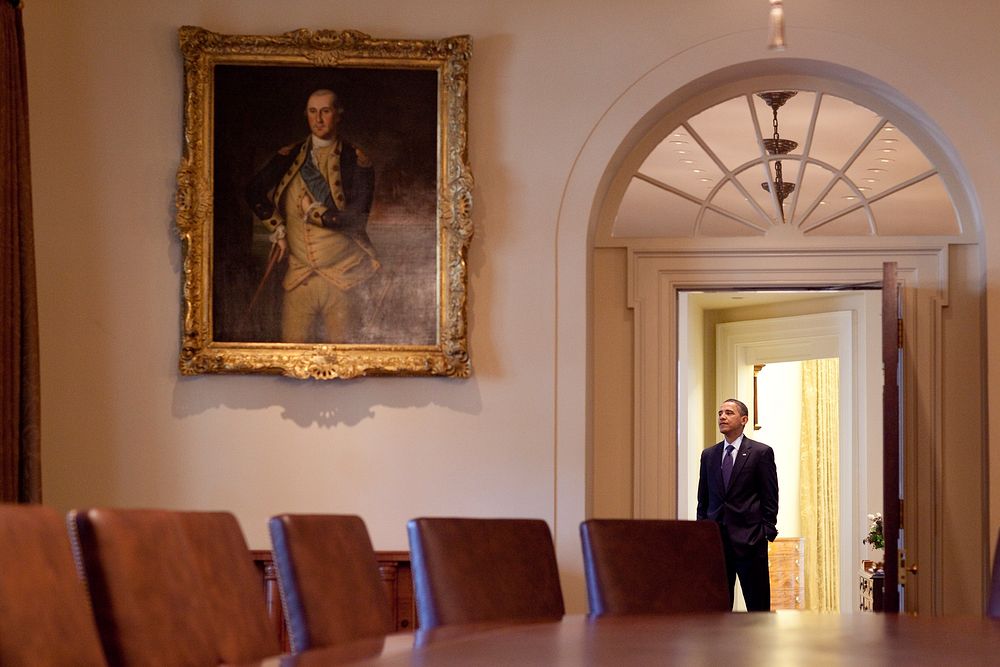 President Barack Obama stands in the Outer Oval Office, viewed from the Cabinet Room of the White House, Jan. 7, 2010.