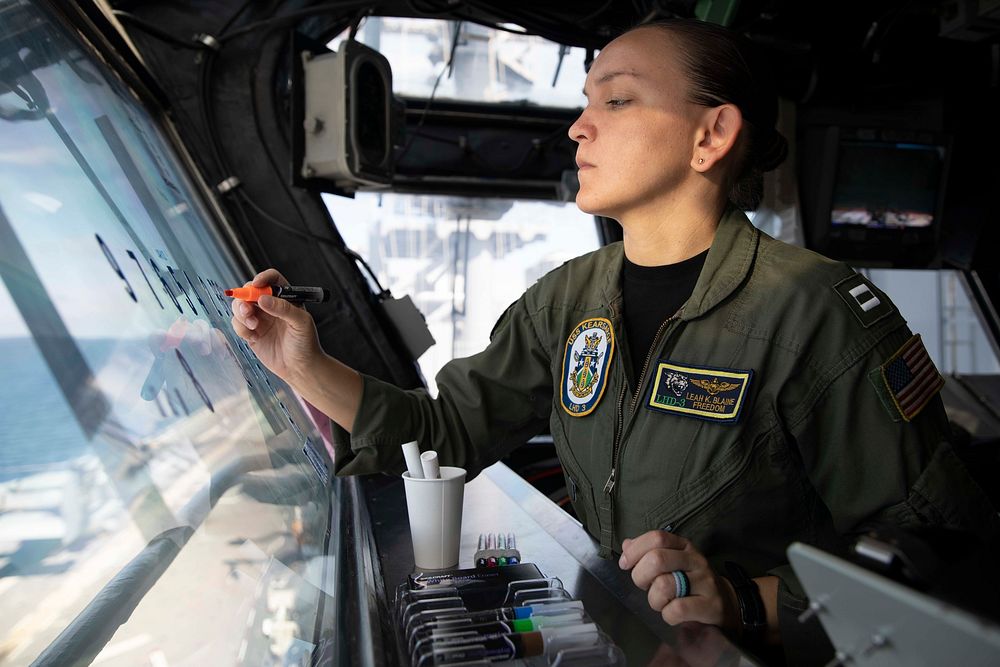 U.S. Navy Lt. Leah Blaine charts flight deck activity in primary flight control during flight operations aboard the Wasp…