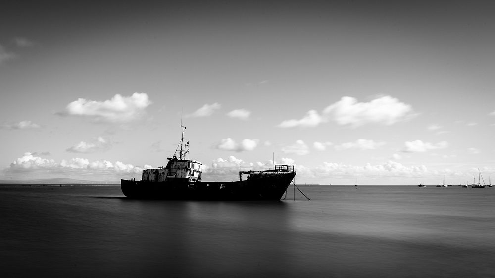 Black and white ship in the ocean. Original public domain image from Flickr