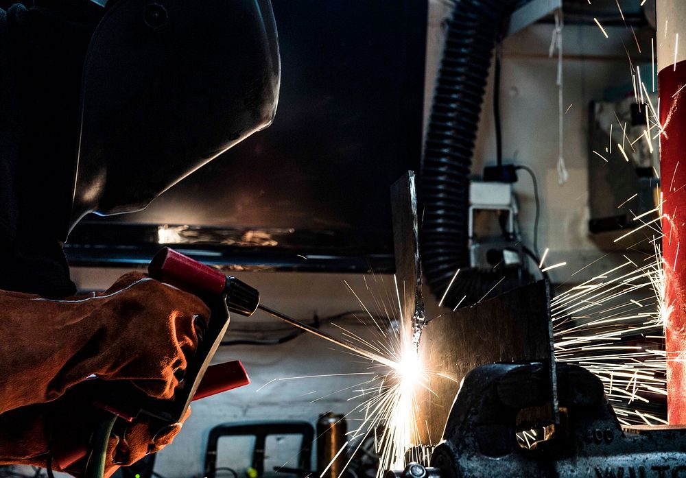 MEDITERRANEAN SEA. Damage Controlman 3rd Class Matthew Webb practices using a portable exothermic cutting unit aboard the…