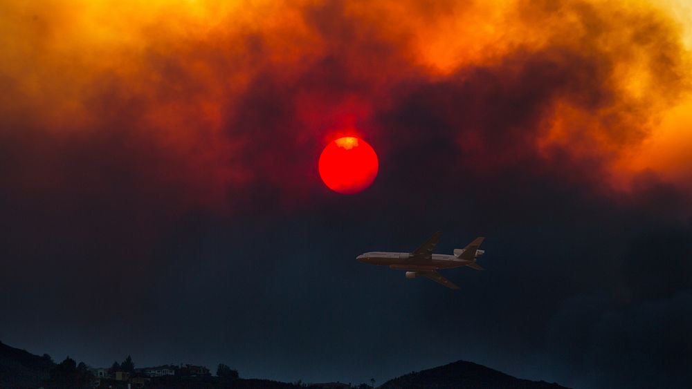 A DC10 Air Tanker is seen over the Woolsey Fire in California. (Photo courtesy of Peter Buschmann). Original public domain…