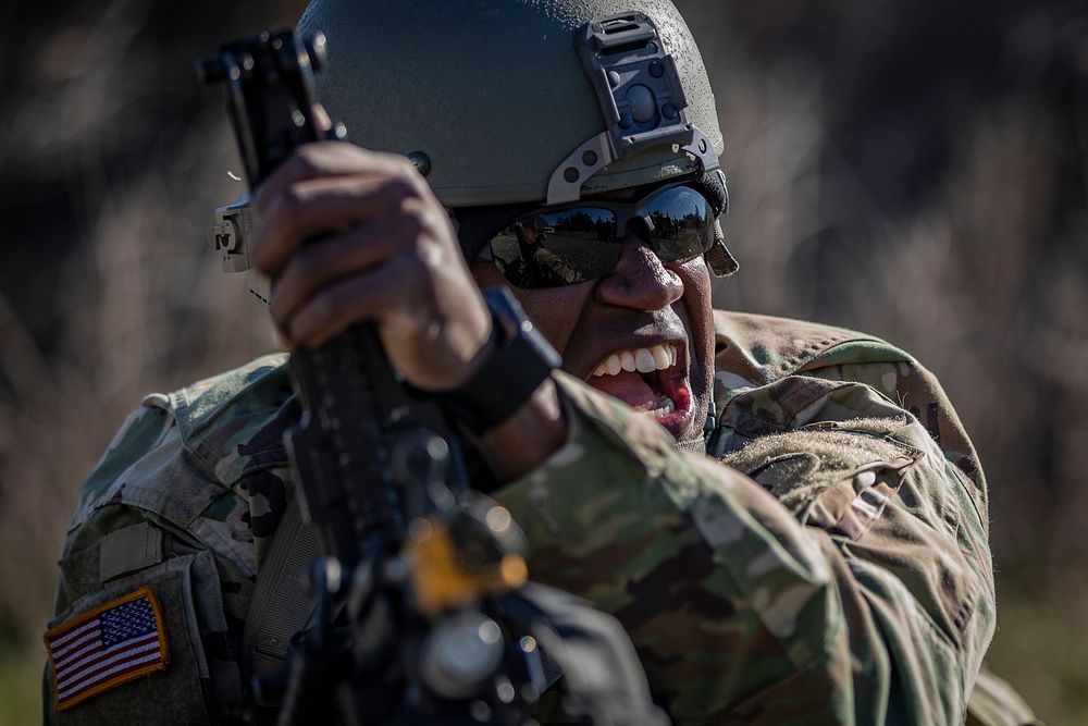 U.S. Army Sgt. Aaron Edgerton demonstrates how to reload an M249 Squad Automatic Weapon during training on Joint Base…