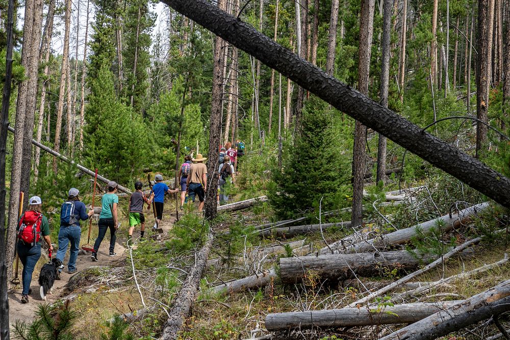 The Highland Cycling Club volunteers make their way to help clear out the trails in Thompson Park in the Butte Ranger…