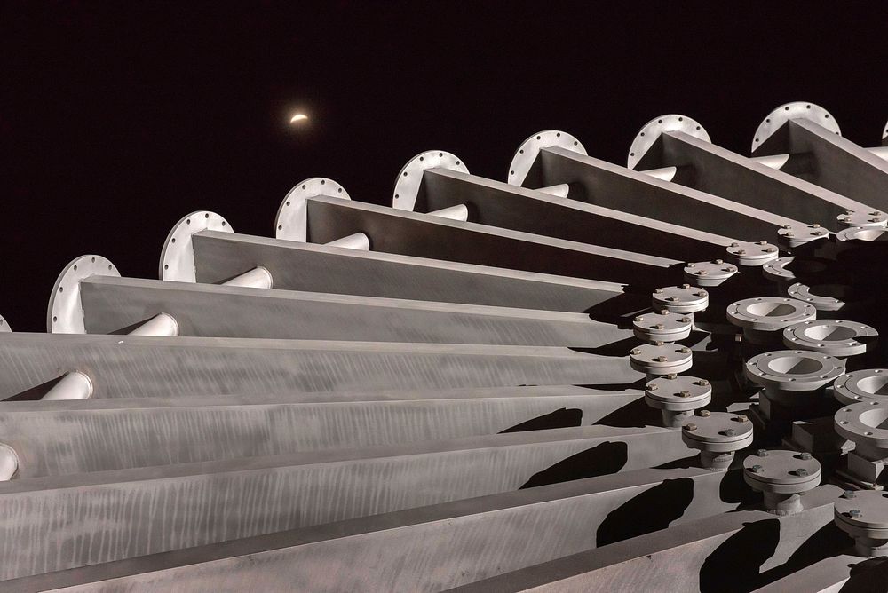 The lunar eclipse rises in the New Mexico sky over the Starburst sculpture at Sandia Labs in Albuquerque.