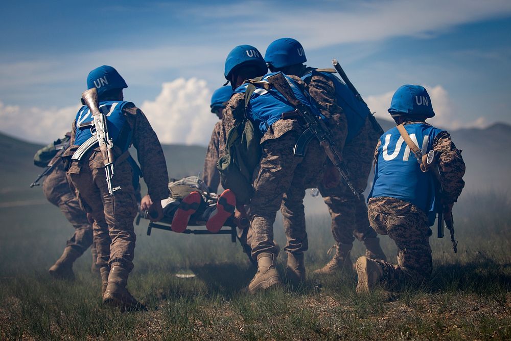 Mongolian Armed Forces service members evacuate a notional casualty during a care-under-fire training scenario for Khaan…