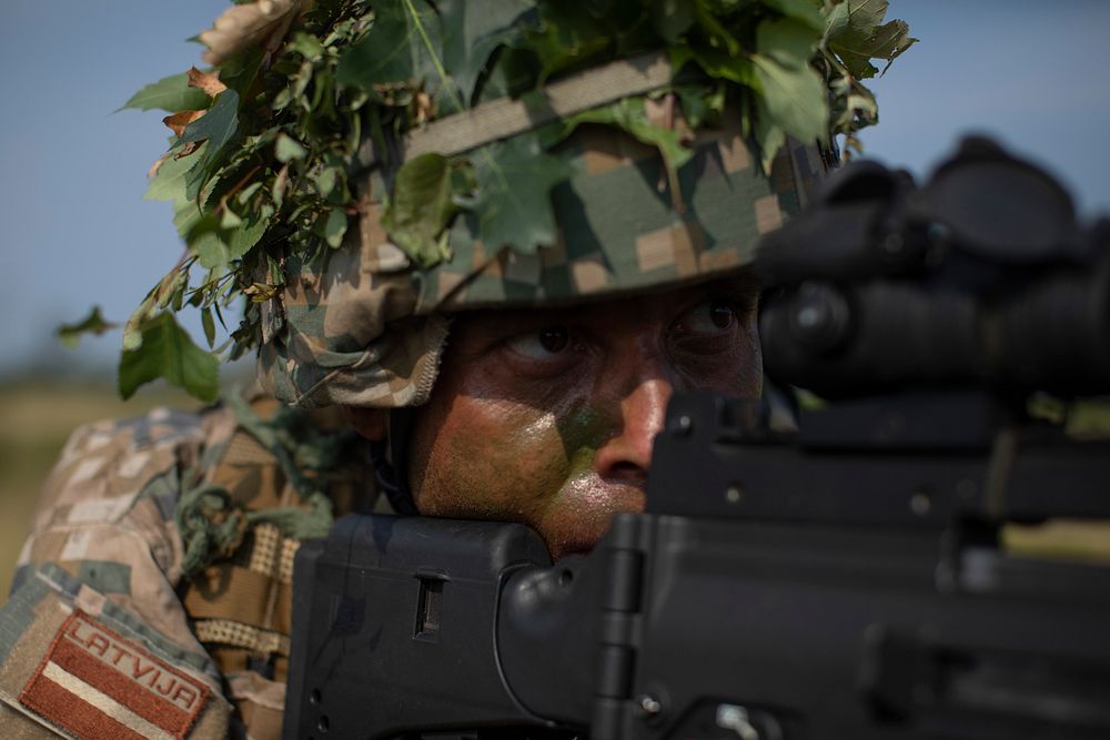 A Latvian Soldier from the Latvian National Guard’s 2nd Brigade, 25th Infantry Battalion aims at targets during tactical…