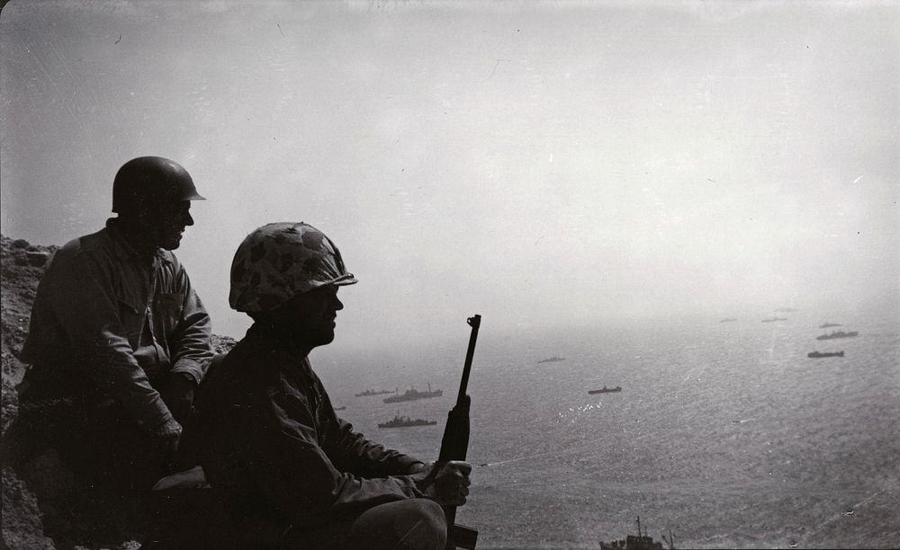 Couple of corpsmen taking a break - looking down from Mount Suribachi at the remainder of the invasion fleet. We were issued…