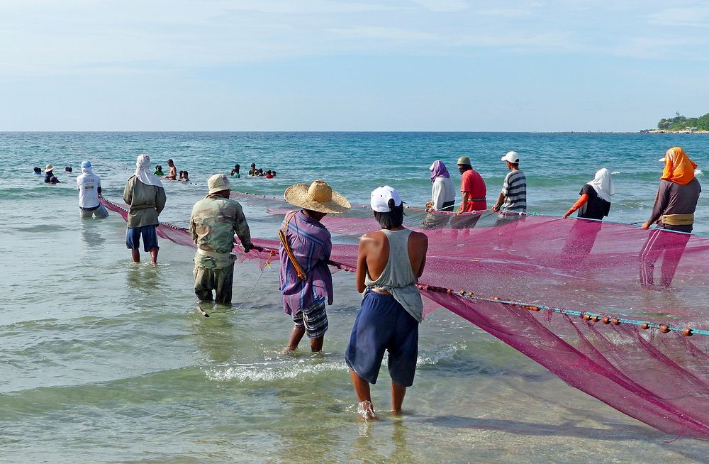Philippines Fishermen.Fishermen pulling ashore there nets. Currimao beach.Philippines. Original public domain image from…