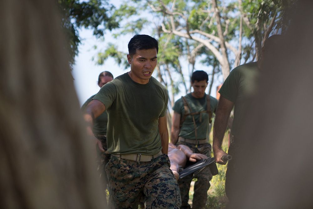 U.S. Navy officers carry a mannequin on a stretcher during the North County Corpsman Cup on Camp Pendleton. (U.S. Marine…