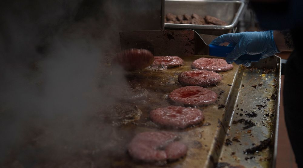 ARCTIC OCEAN (May 6, 2020) Culinary Specialist Seaman Apprentice Emilie M. Wright grills burger patties in the galley aboard…