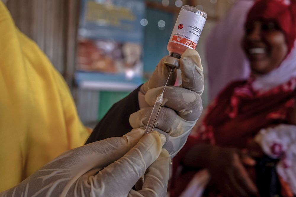 A health worker prepares an immunization shot for a child, in Kahda district of Mogadishu, Somalia, on 1 September 2020.