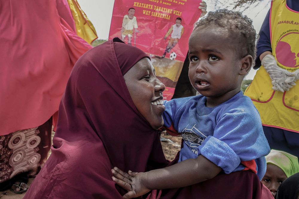 A mother holds her child as she awaits her turn for vaccination, at a health center in Kahda district of Mogadishu, Somalia…