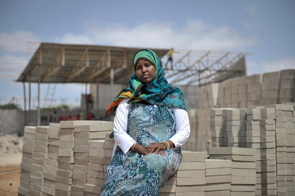 Naema Adam, who began a brick-making business, sits in front of her factory in the Somali capital, Mogadishu on 20 January…