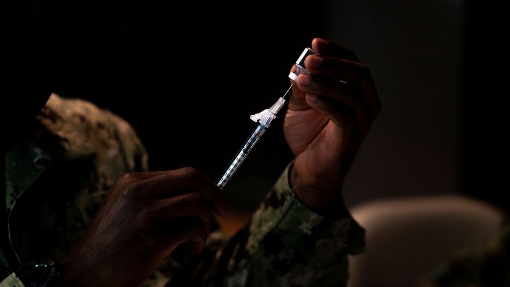 Deploying Marines and Sailors receive COVID-19 vaccine.