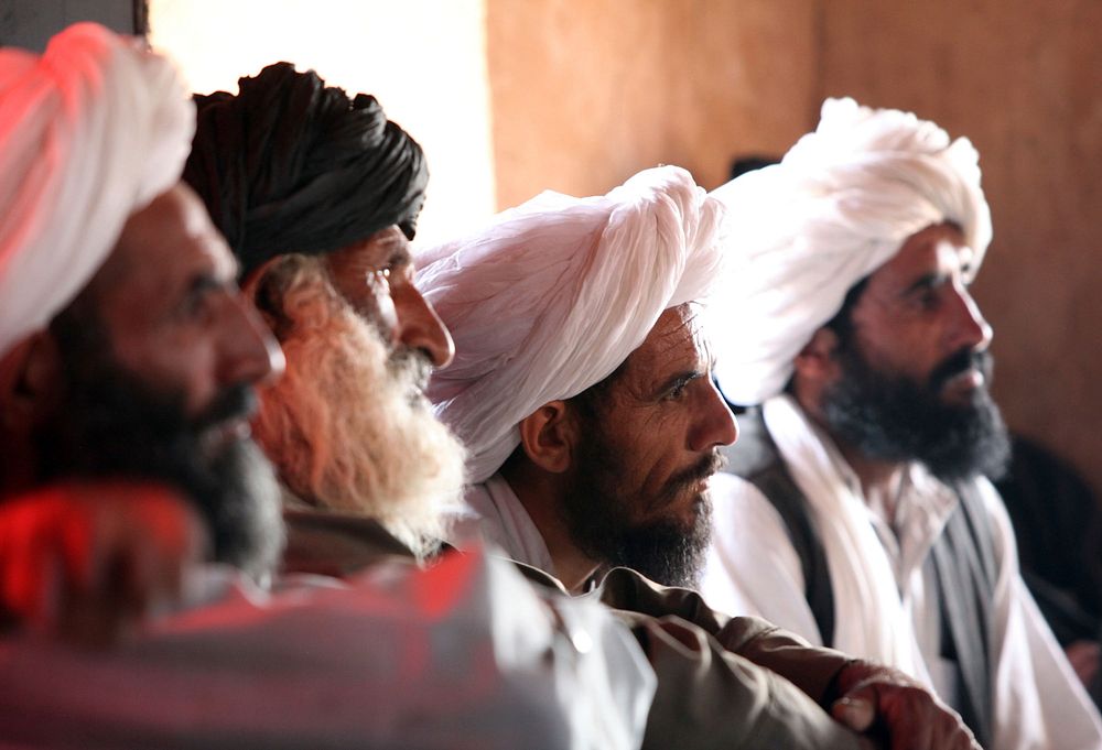 Afghans listen in on a council meeting with Marines