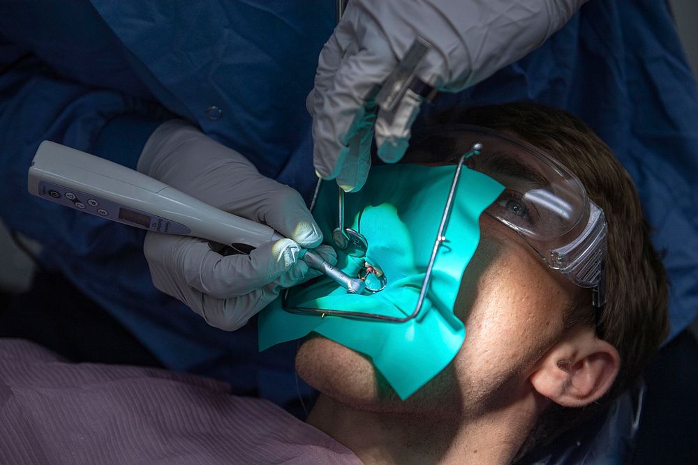 SOUTH CHINA SEA (April 6, 2021) &ndash; U.S. Navy Lt. John Miller, from Seal Beach, Calif., performs a root canal on…