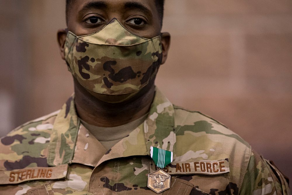 U.S. Air Force Senior Airman Solomon Stirling stands for a portrait after being awarded the Army Commendation Medal for his…