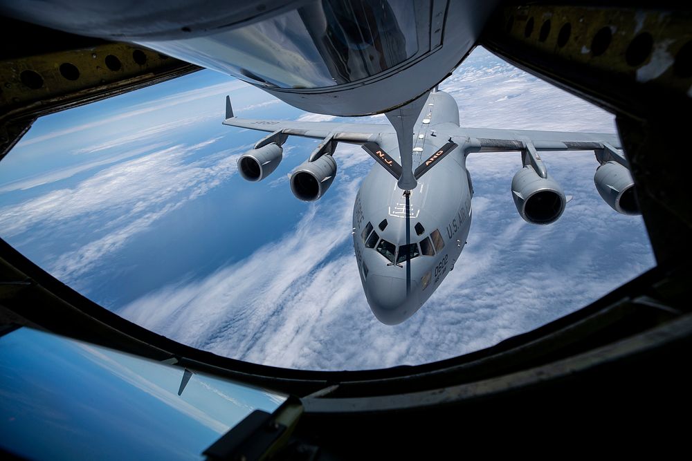 A U.S. Air Force C-17 Globemaster III with the North Carolina Air National Guard's 145th Airlift Wing flies behind a KC-135R…