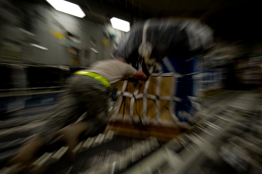 A U.S. Airman with the 8th Expeditionary Air Mobility Squadron loads cargo onto a C-17 Globemaster III aircraft for an air…