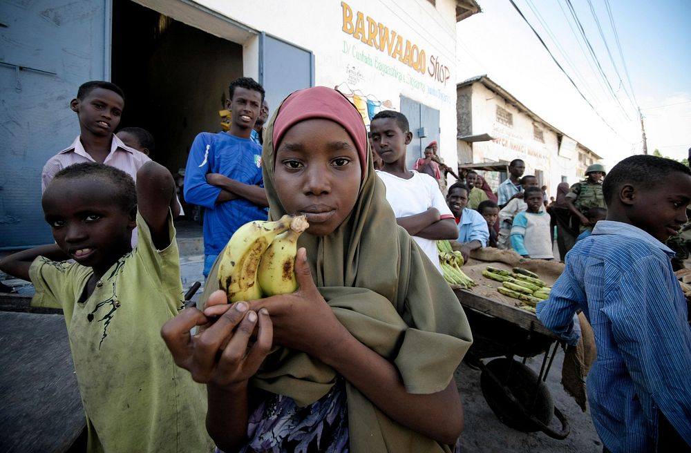 A young Somali girl holds bananas in Torfiq market in the Yaaqshiid District of northern Mogadishu.
