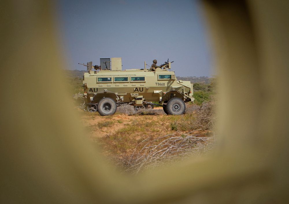 An African Union Mission in Somalia (AMISOM) armoured personnel carrier is seen through a rifle hole of another 20 January…