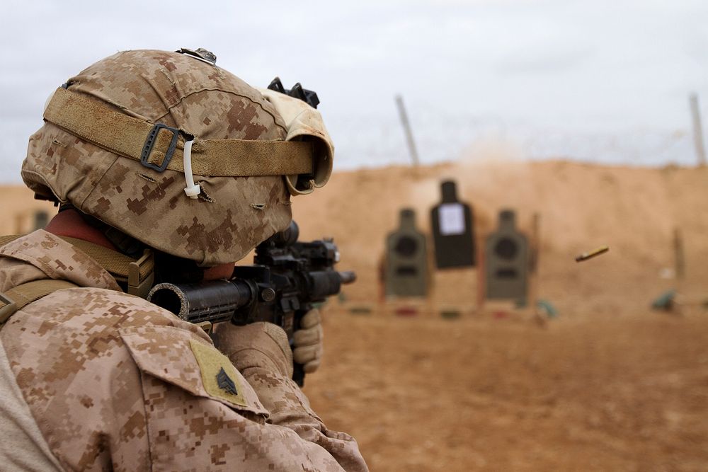 U.S. Marine Sgt. Jacob Daniel Melrose, an armory chief assigned to Regimental Combat Team 5, uses an M4 carbine while…