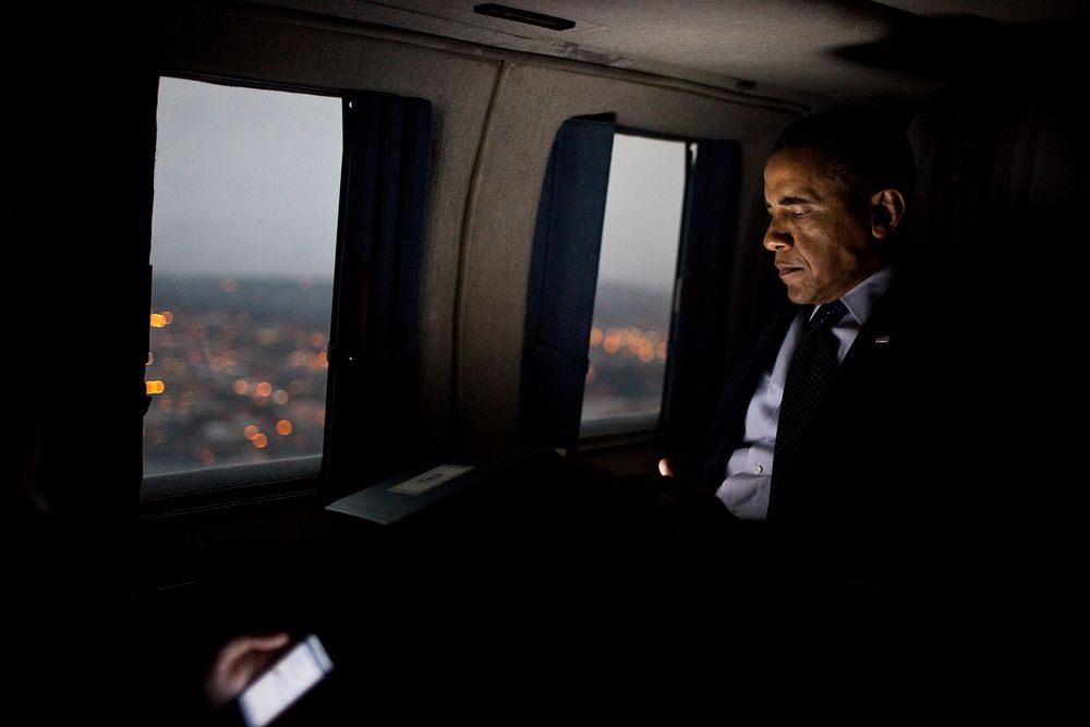 President Barack Obama reads from a tablet computer during a flight aboard Marine One en route to Everett, Wash., Feb. 17…