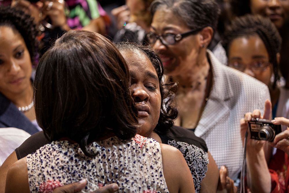 First Lady Michelle Obama hugs a woman during a Girls Inc. luncheon at Century Link Center, in Omaha, Neb., April 24, 2012.