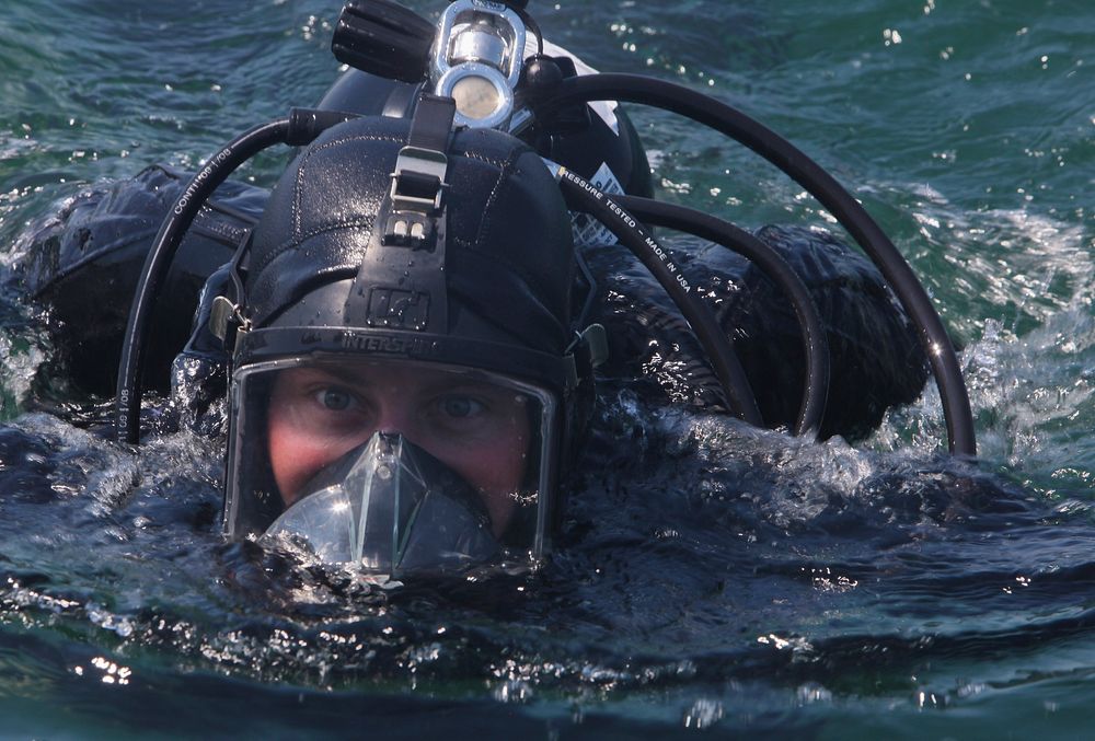 U.S. Marine Corps Sgt. Travis Hough, with Black Sea Rotational Force (BSRF) 12, swims to the dive platform during training…