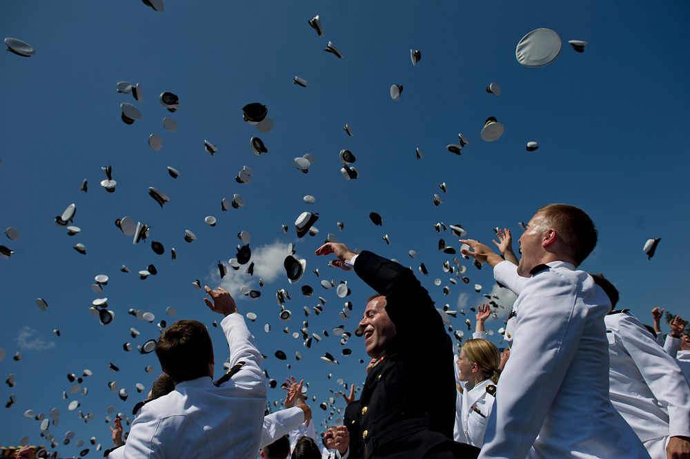 Graduating midshipmen toss their caps at the conclusion of the U.S. Naval Academy graduation and commissioning ceremony May…