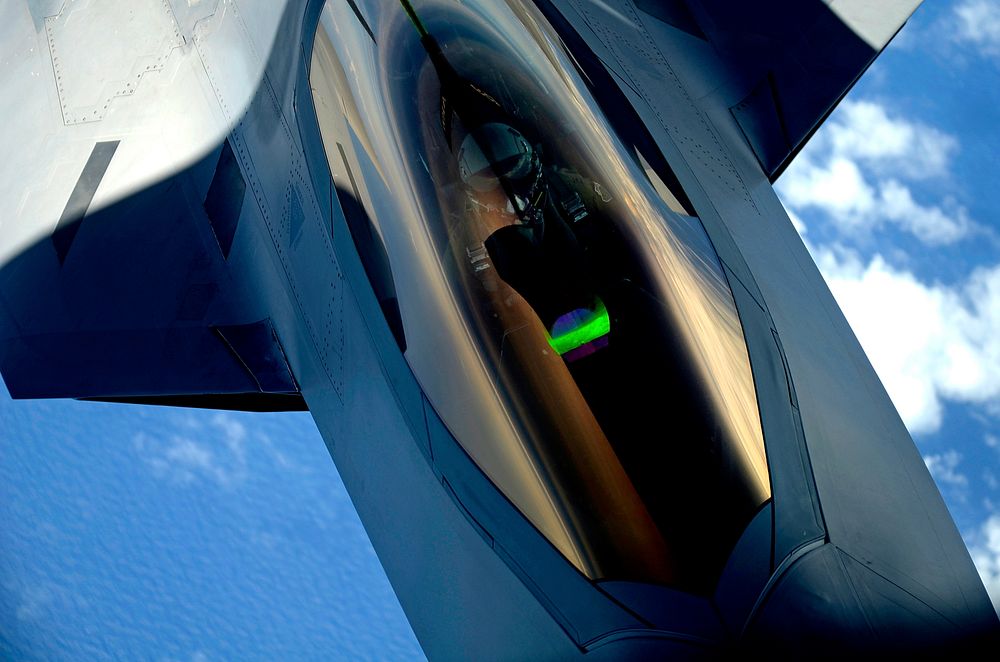 A U.S. Air Force F-22 Raptor aircraft with the 1st Fighter Wing receives a midair refueling from a KC-135 Stratotanker…