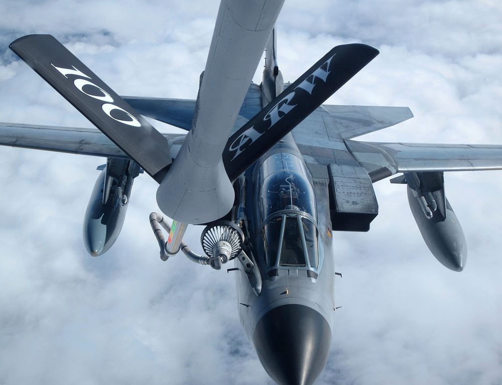 A U.S. Air Force KC-135 Stratotanker cargo aircraft assigned to the 100th Air Refueling Wing refuels a German air force…