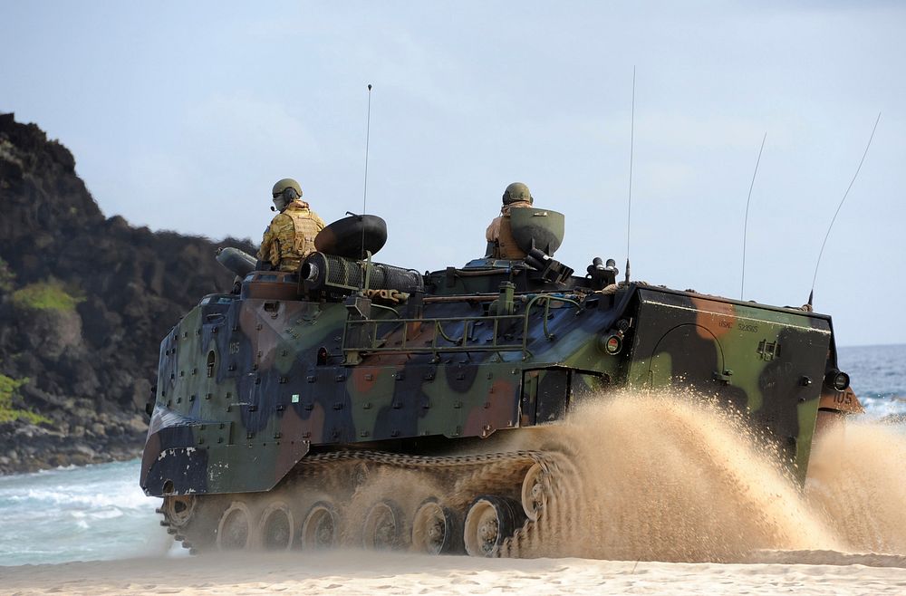 U.S. Marines with Combat Assault Company, 3rd Marine Regiment drive an amphibious assault vehicle onto the beach at Marine…