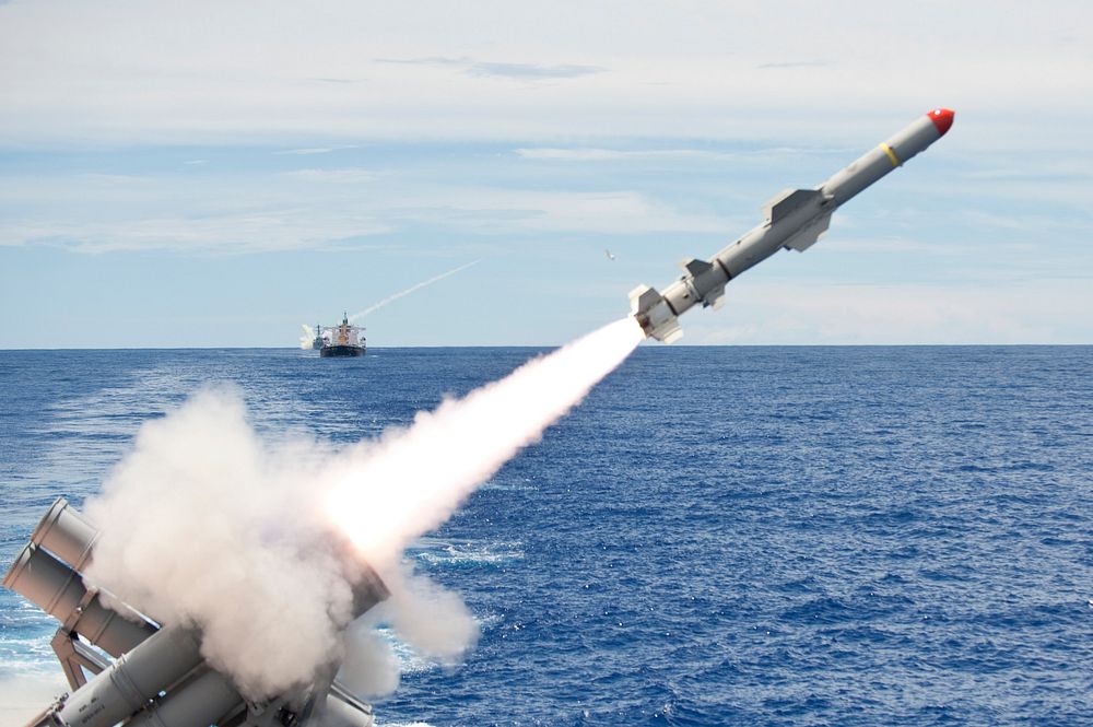 An AGM-84 Harpoon missile launches from the aft missile deck of the guided missile cruiser USS Cowpens (CG 63) in the…