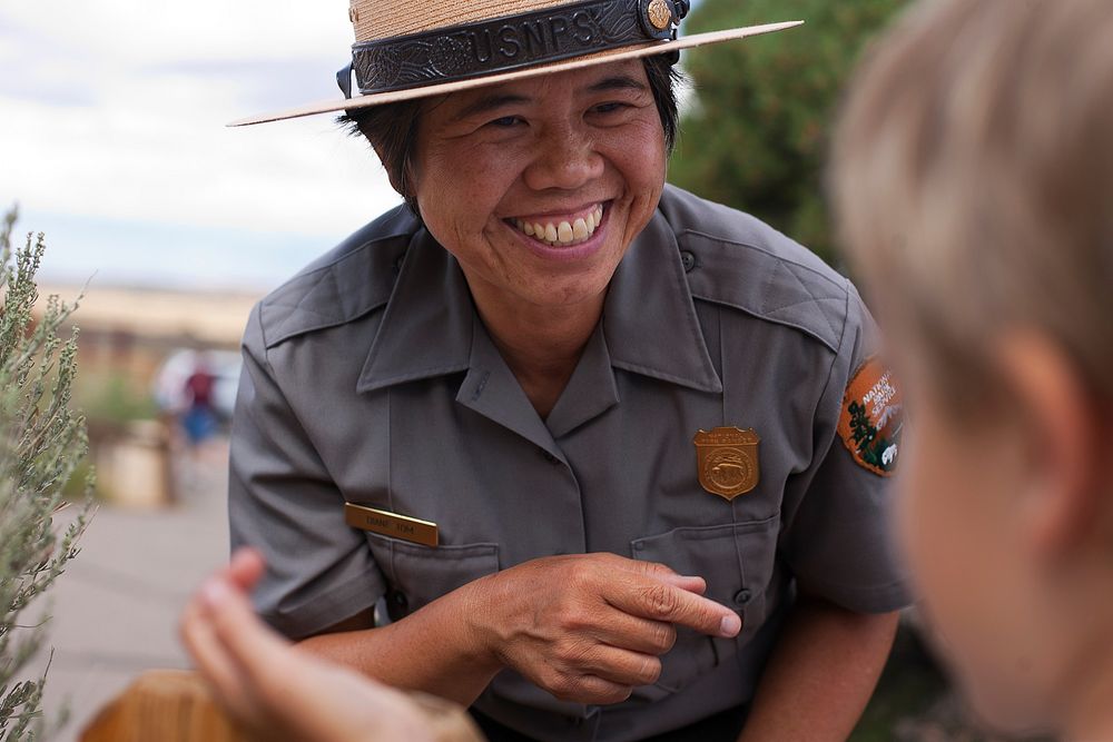 Diane Tom talks with a junior ranger. (NPS Photo by Andrew Kuhn). Original public domain image from Flickr